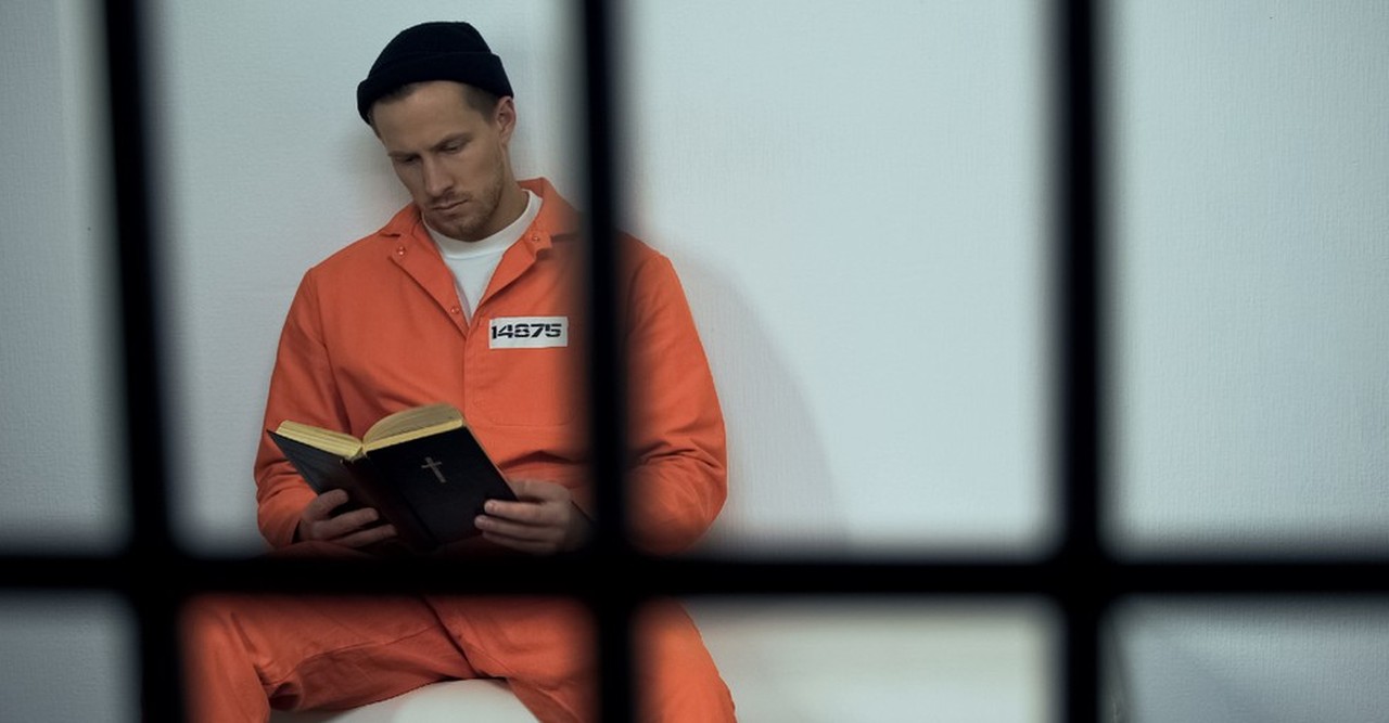 prisoner reading the bible in jail