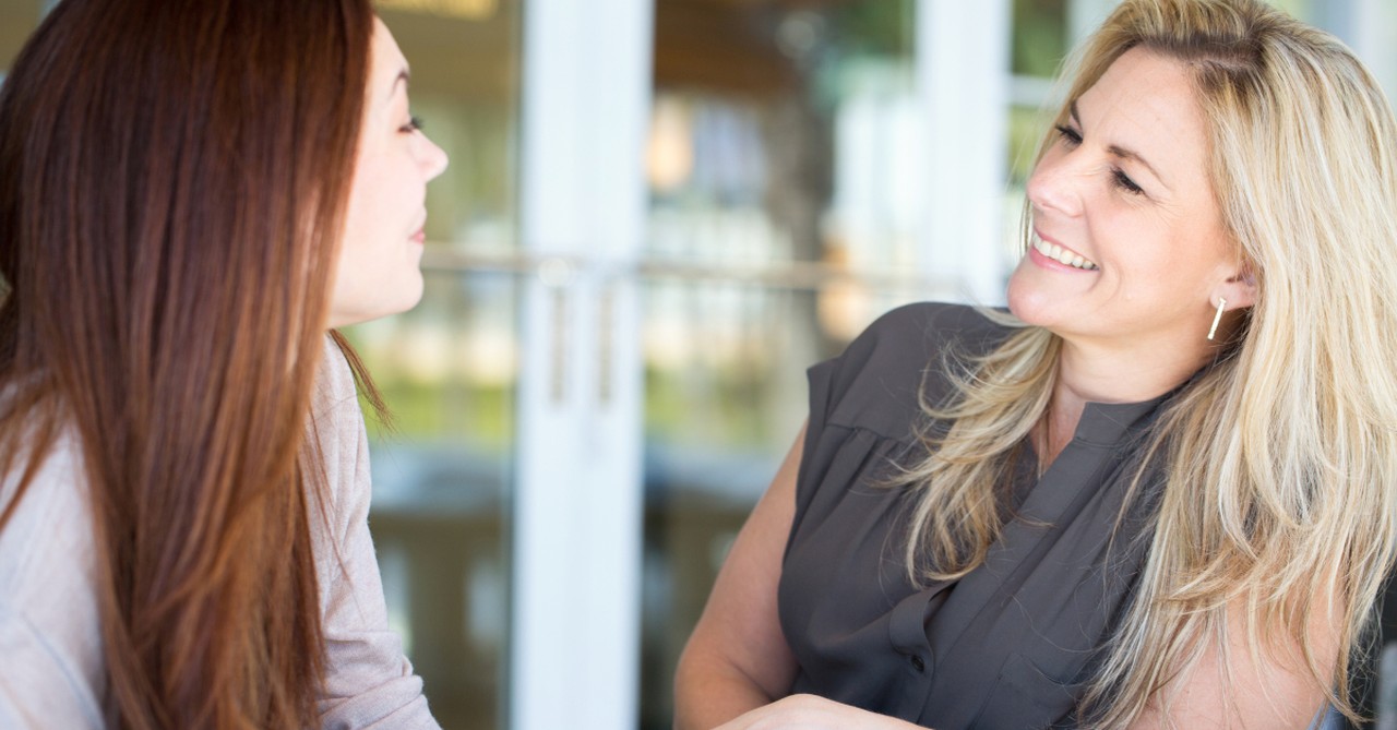 older woman godmother mentoring younger woman