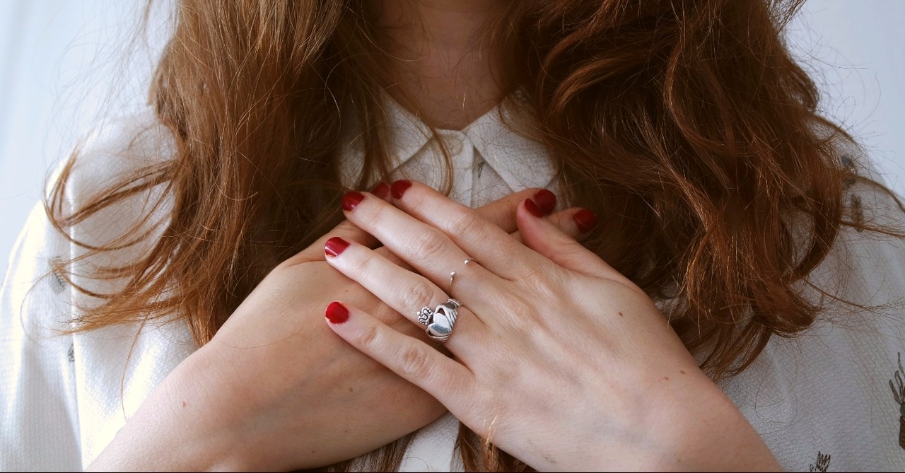 Woman with hands over heart