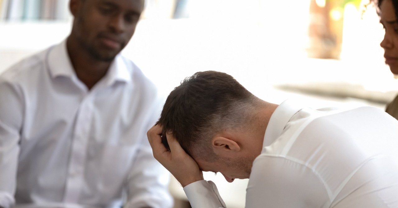 man dealing with addiction talking with honest friends