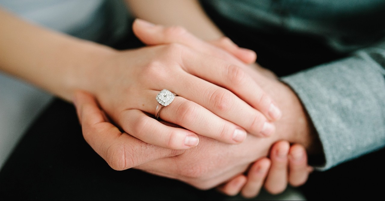 Husband and wife's hands clasped