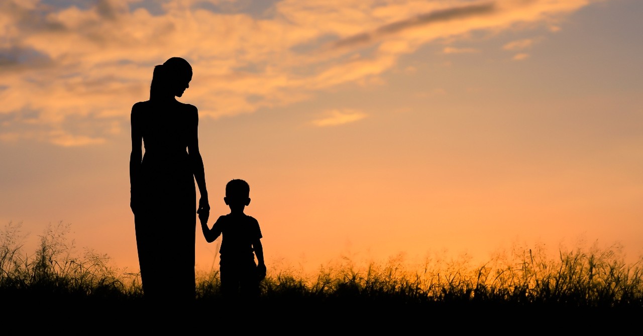 Mother silhouetted with her son