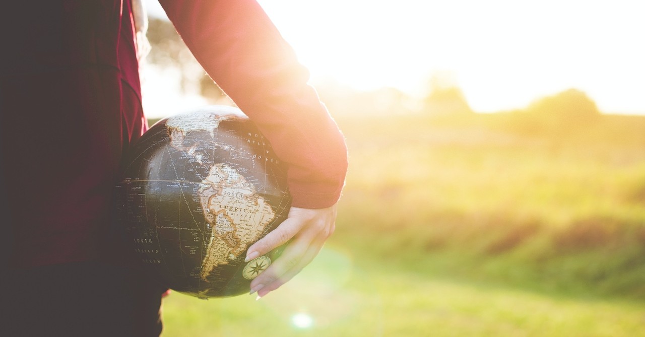 Woman holding a black globe