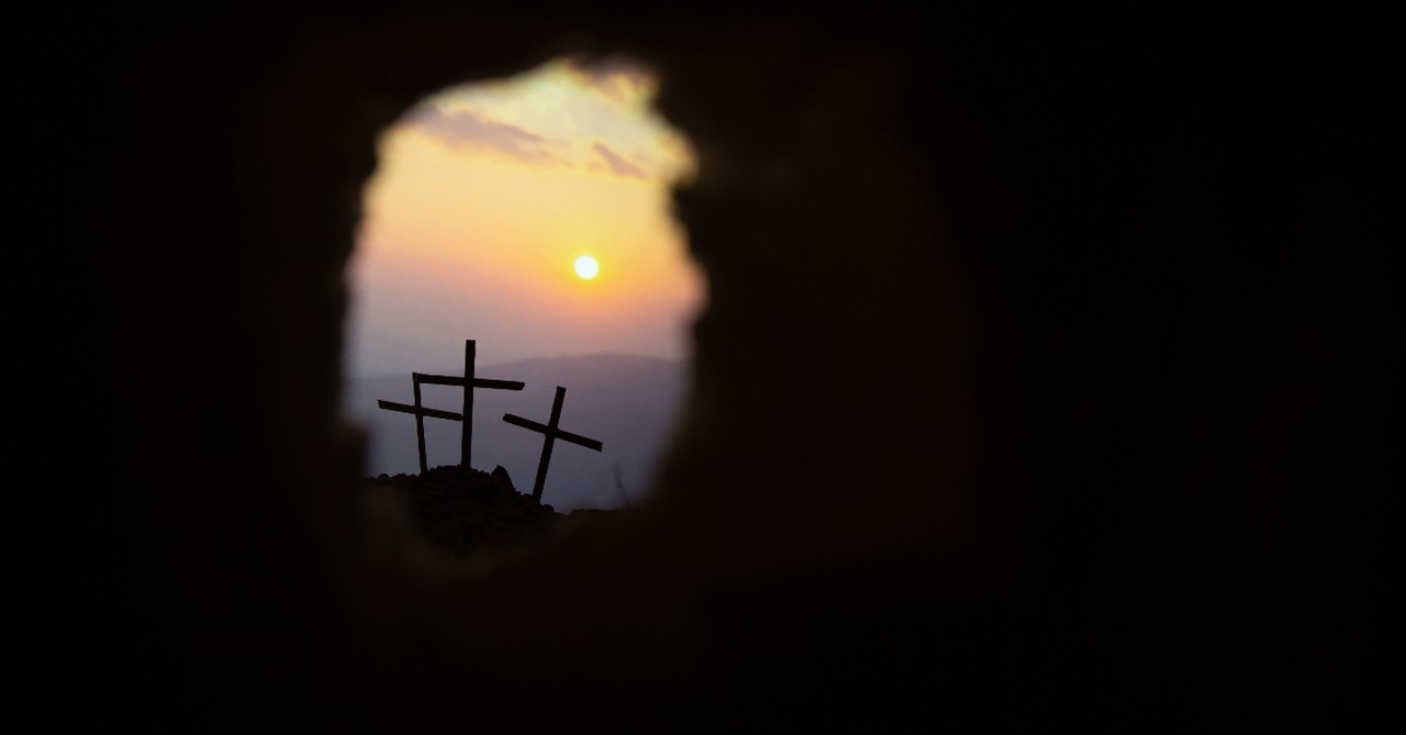 view from empty tomb looking at three crosses, he is not here for he is risen