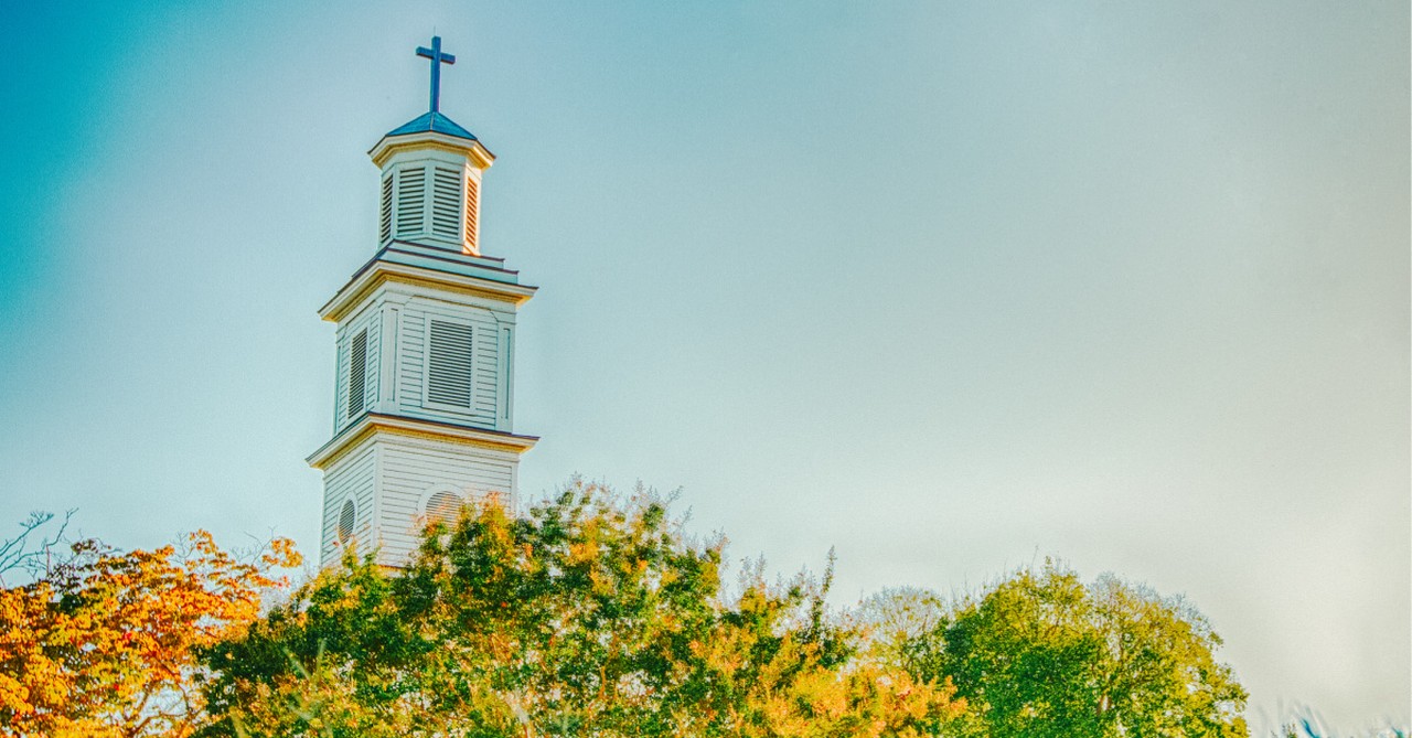 A Church steeple against a blue sky