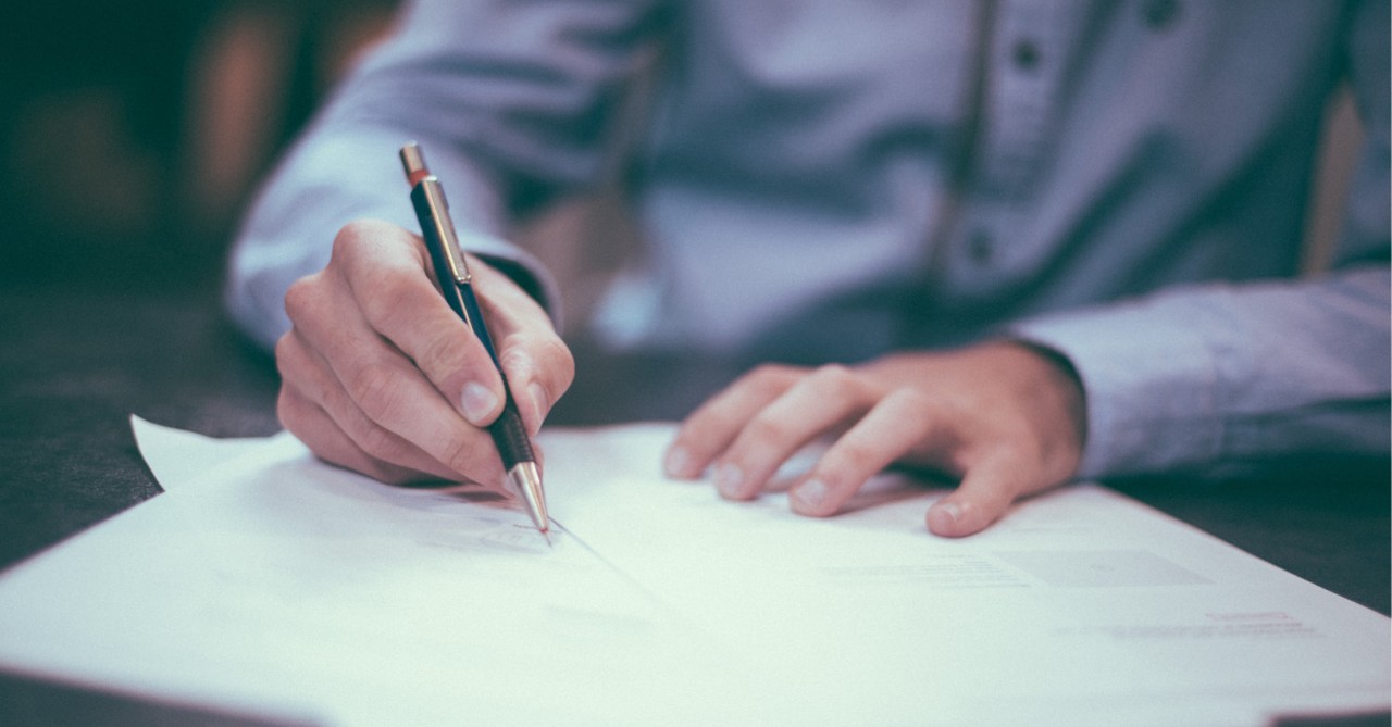 Man signing a letter, Evangelical leaders sign an statement urging other evangelicals to be kind and take the high road