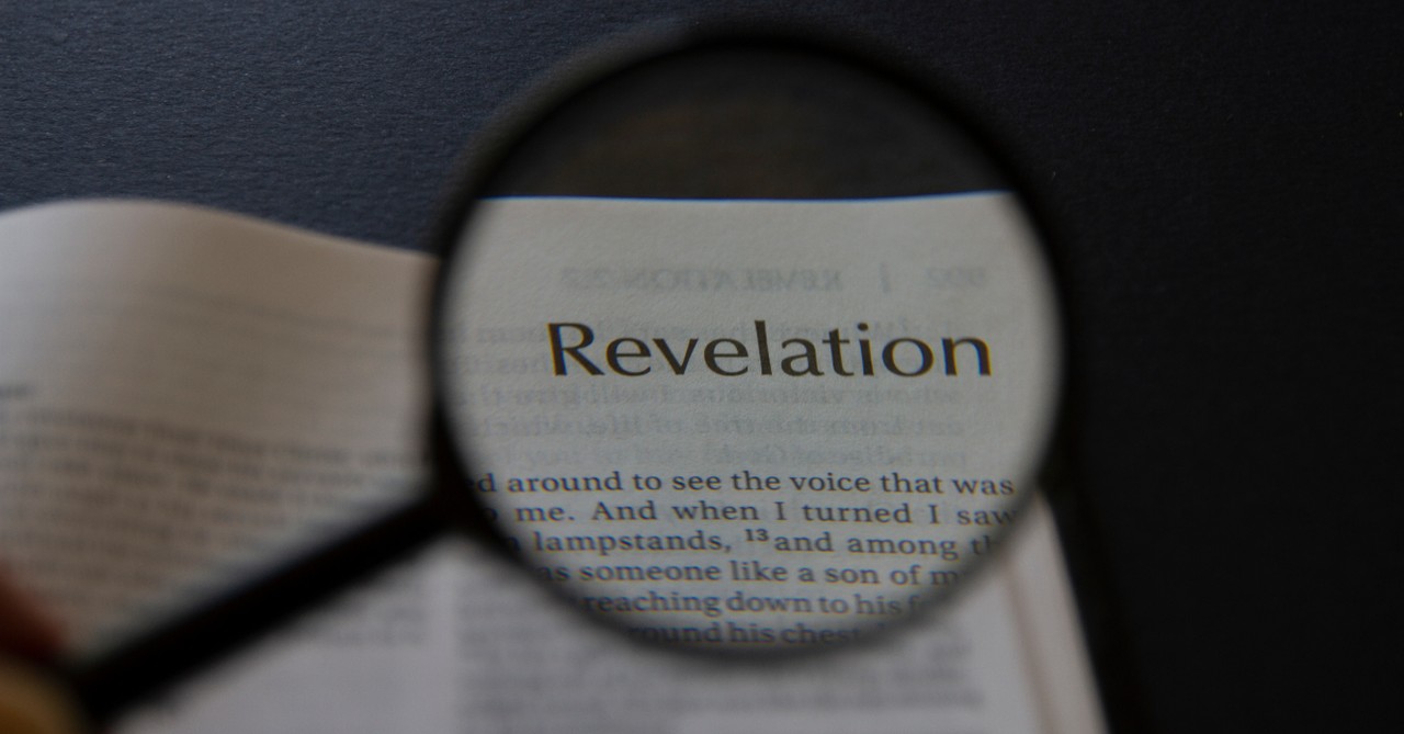 bible open to revelation with magnifying glass, hell in book of revelation