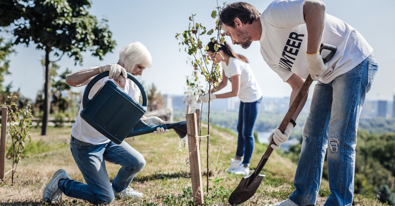 boomer and millennials volunteering together outdoors