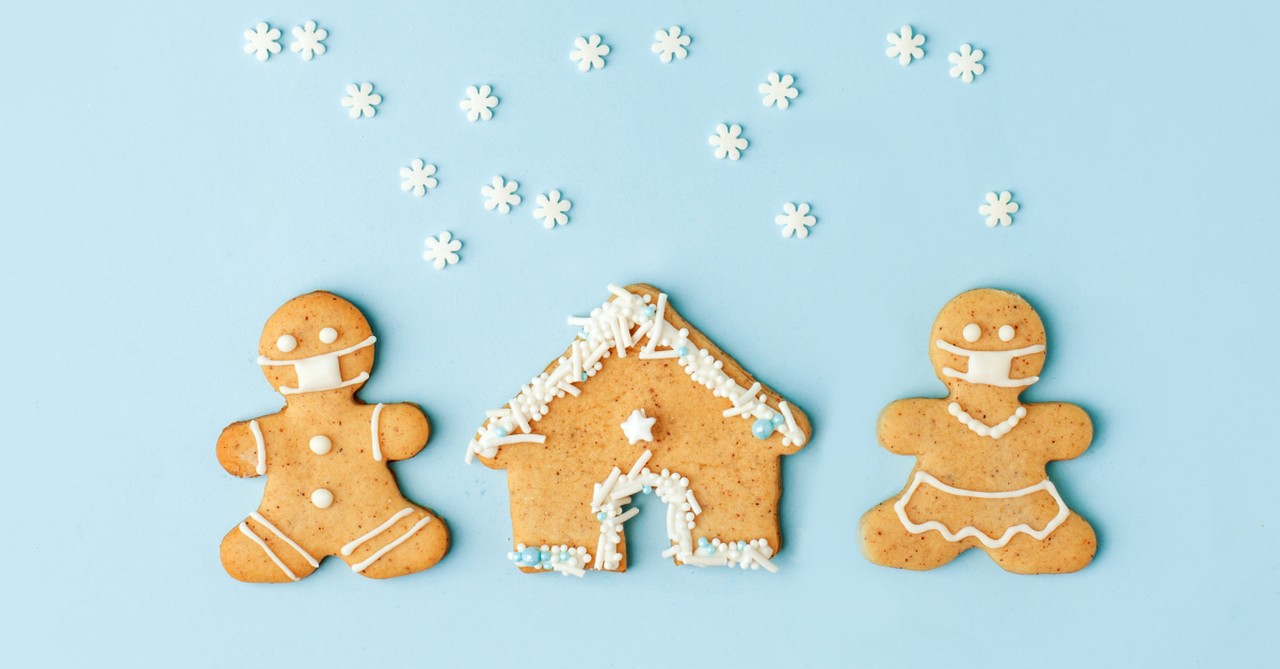 gingerbread couple in christmas snow scene during pandemic wearing face masks