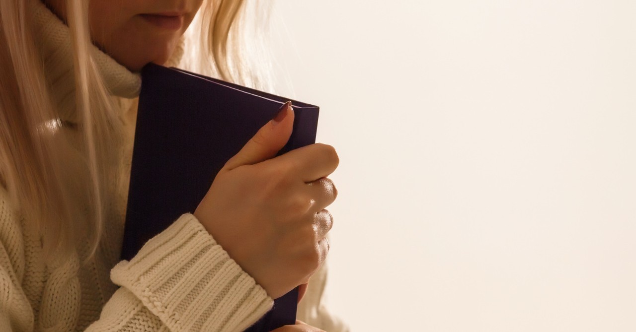 a woman holding a book, live not by lies and the danger of soft totalitarianism