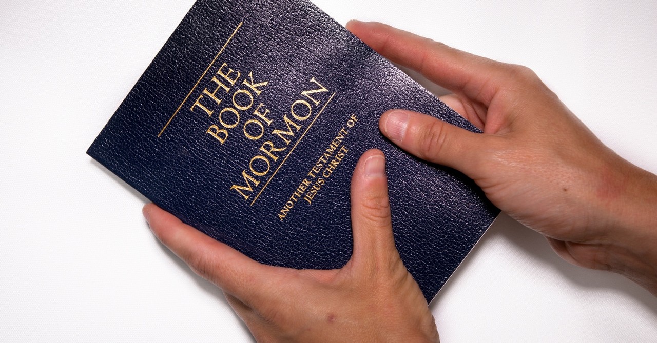 A person holding the Book of Mormon