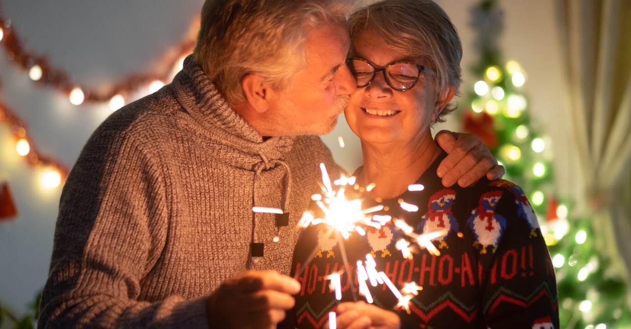 Elderly couple kissing at Christmas