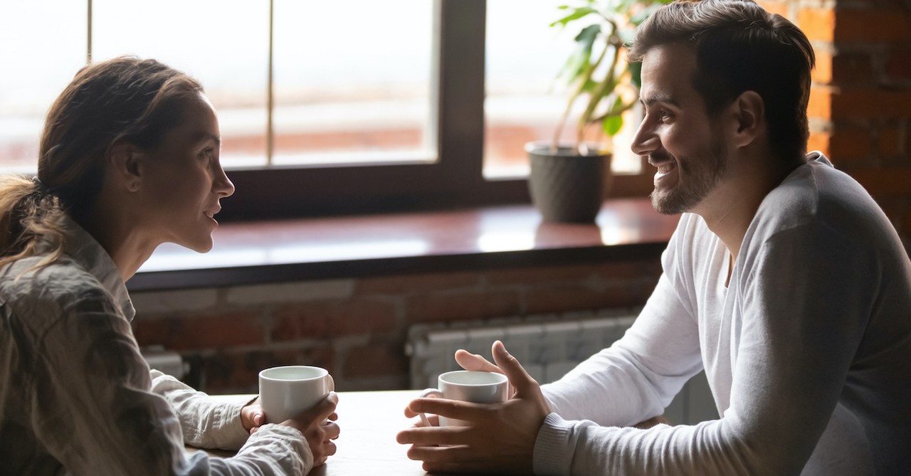 couple happily talking on date at coffee shop, wait for the one god has set aside