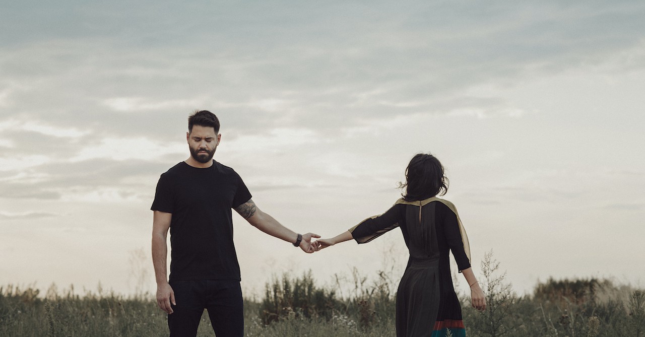 Couple in a field breaking up