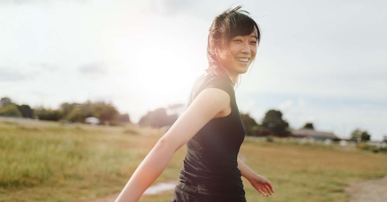 woman walking outside looking happy, how to spiritual retreat