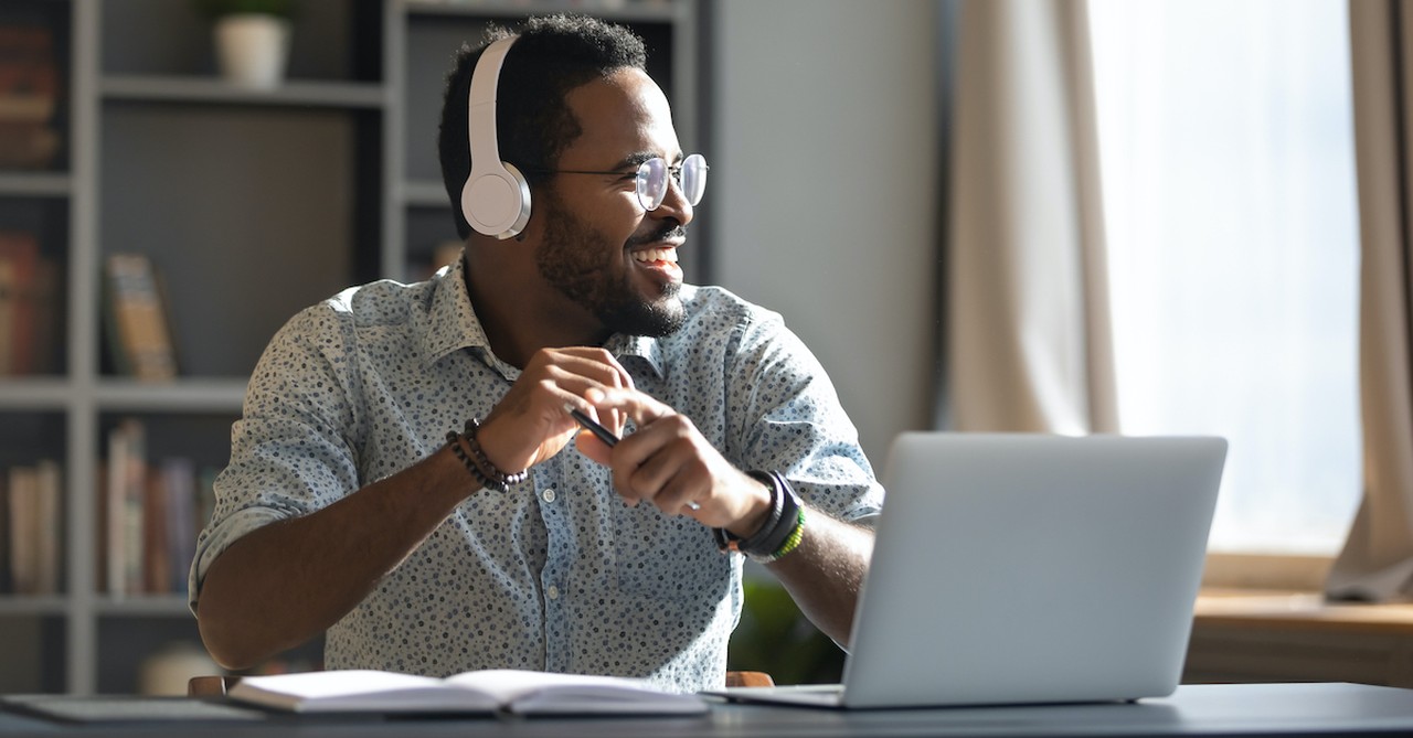 man listening to a podcast on his computer