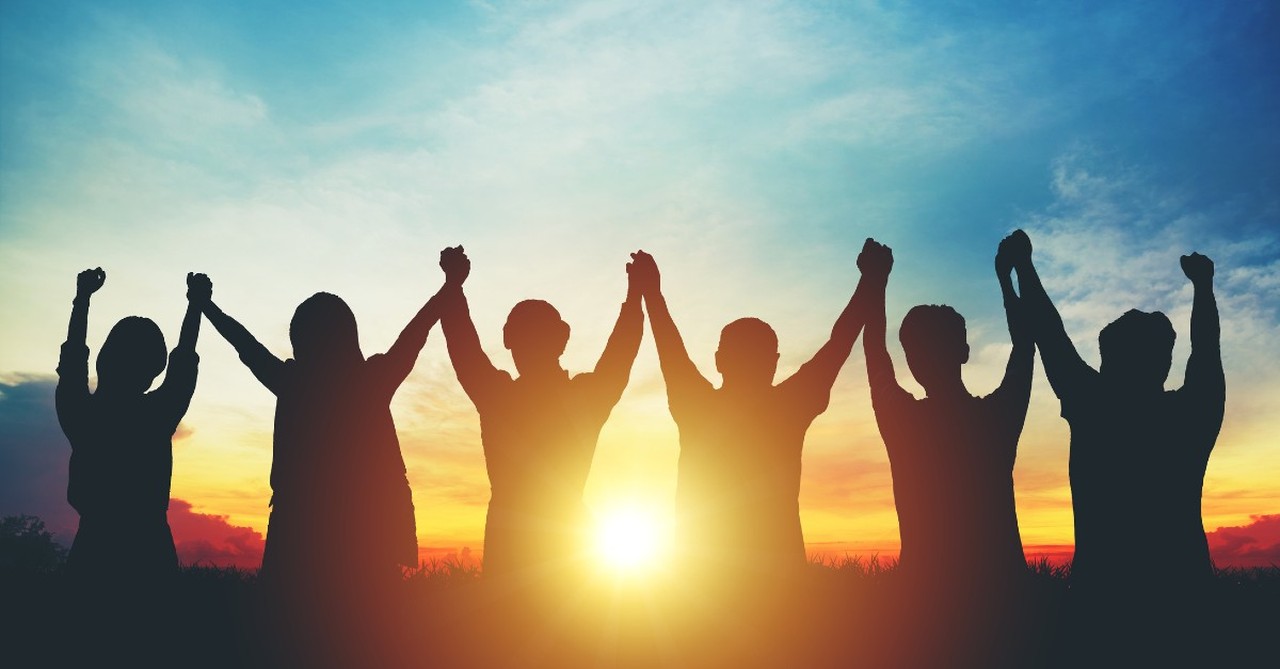 people united together holding hands up