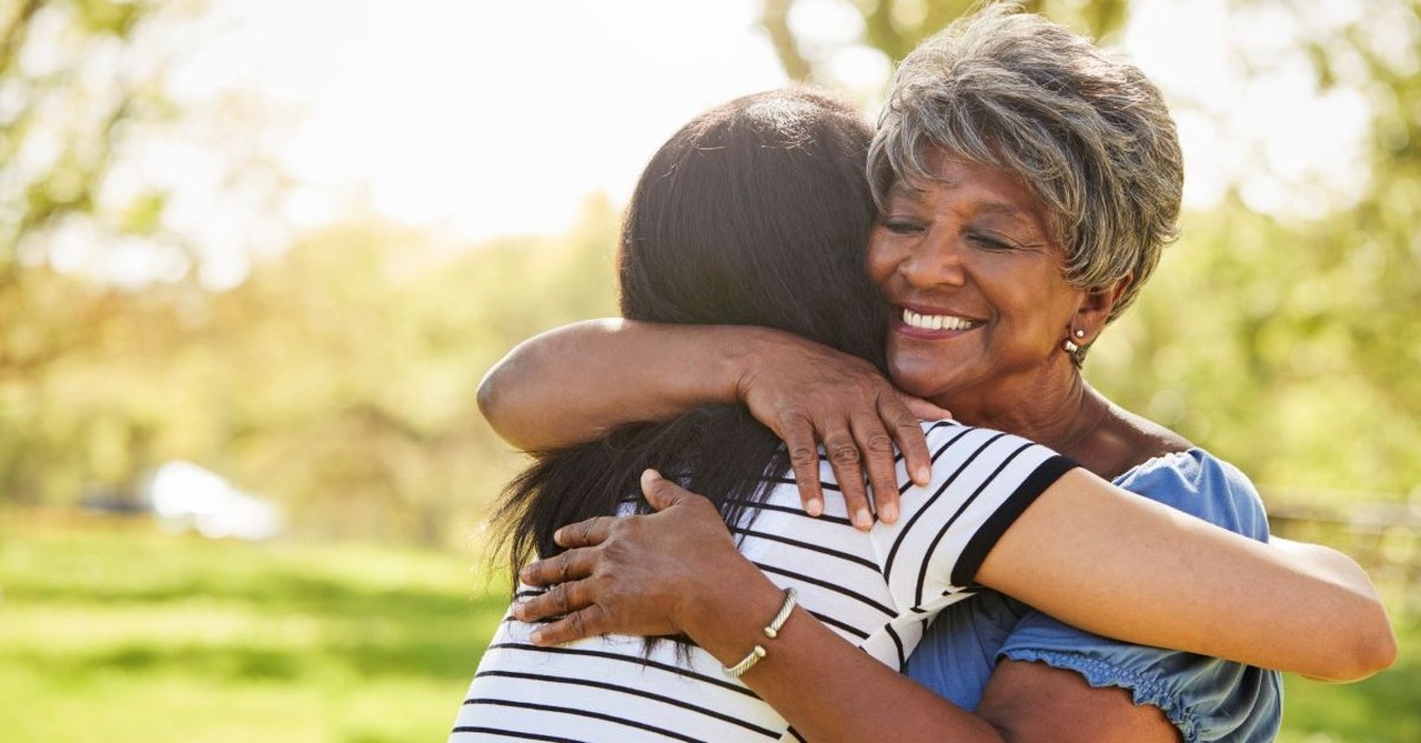 older mother hugging adult child daughter