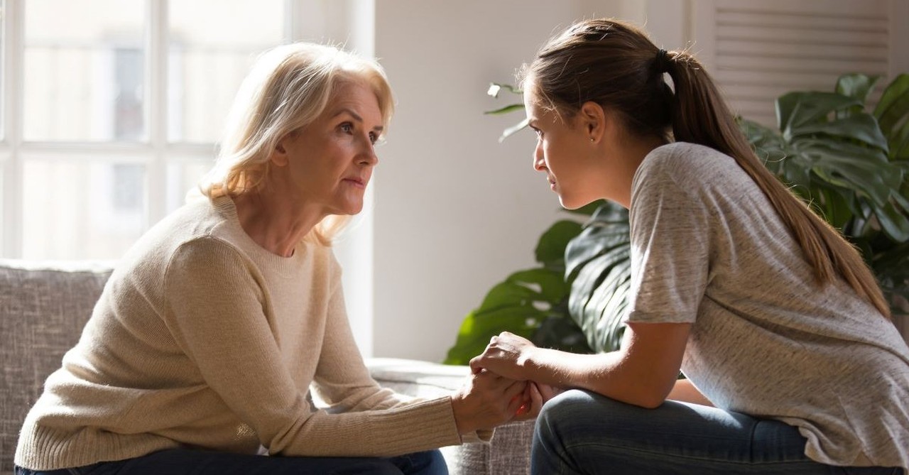 woman on couch talking to mom or mother in law