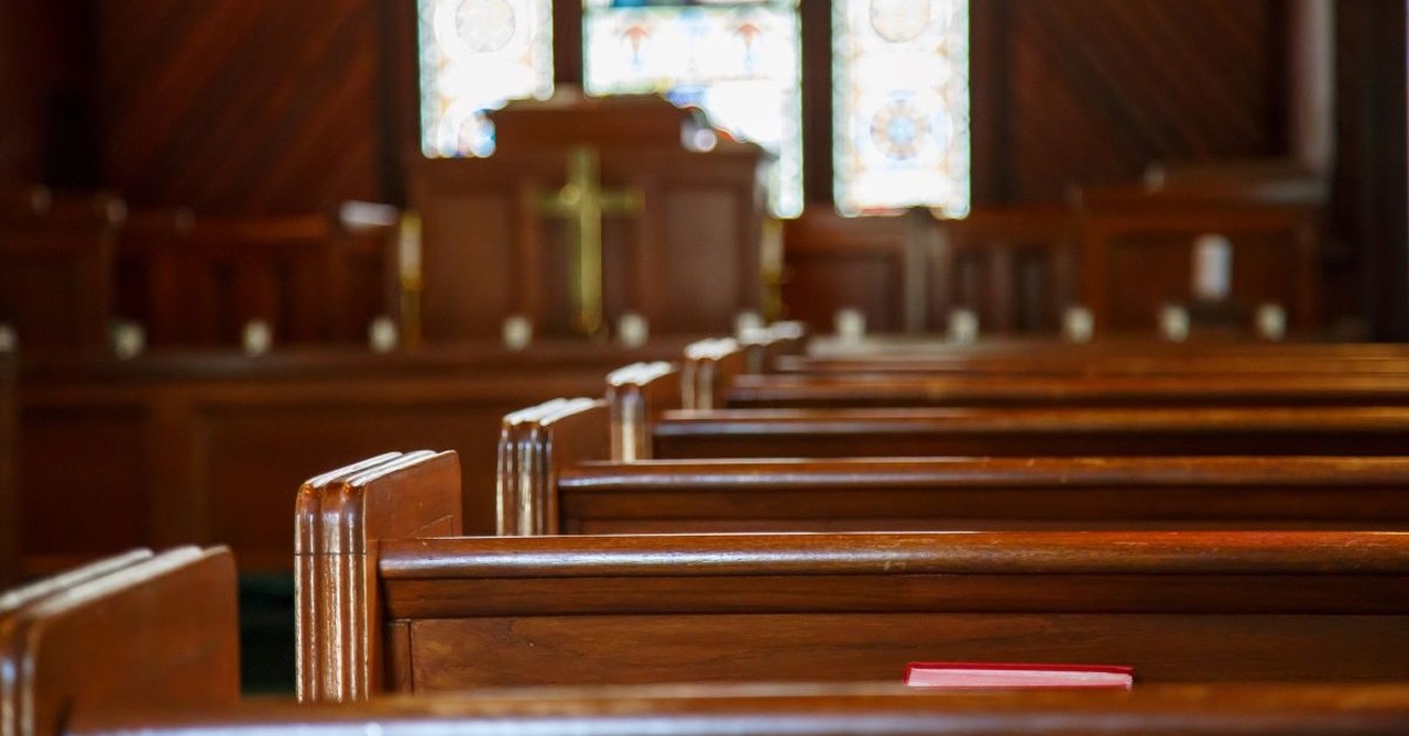 old church pews aisle podium stained glass