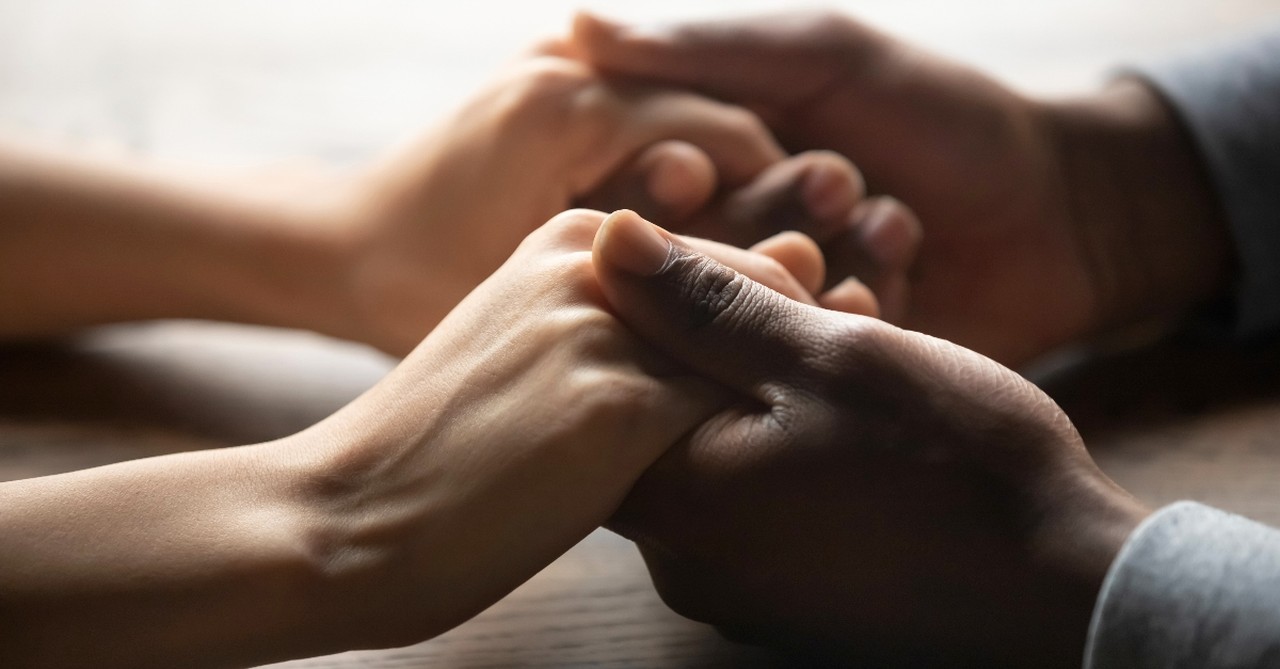 Hands holding in comfort, how to be a blessing to those who are suffering