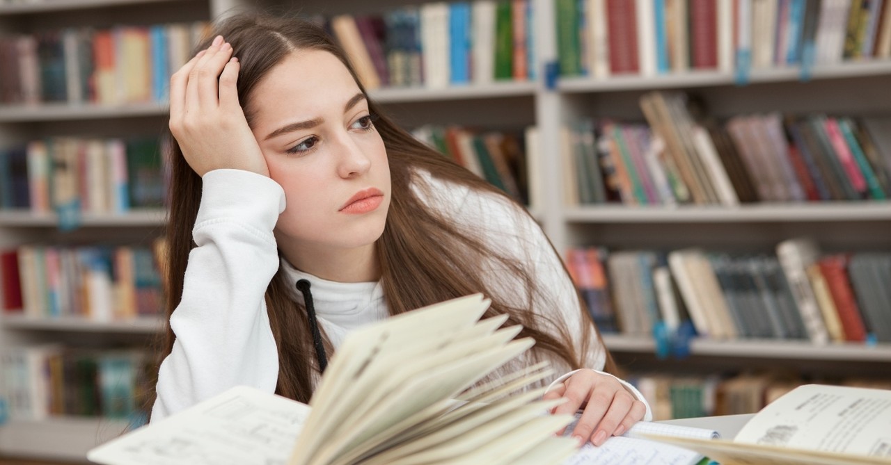 Young girl distracted from schoolwork