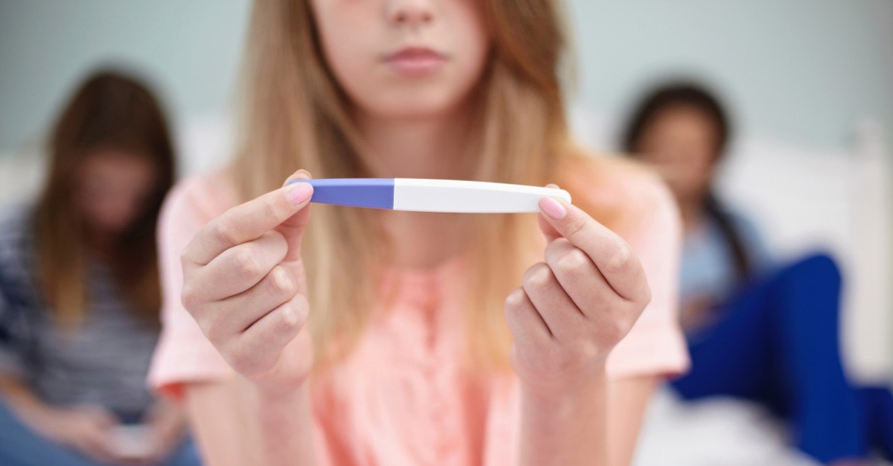 A woman holding a pregnancy test, Appeals Court Overturns Law Requiring Parents Be Notified about Teens’ Abortion