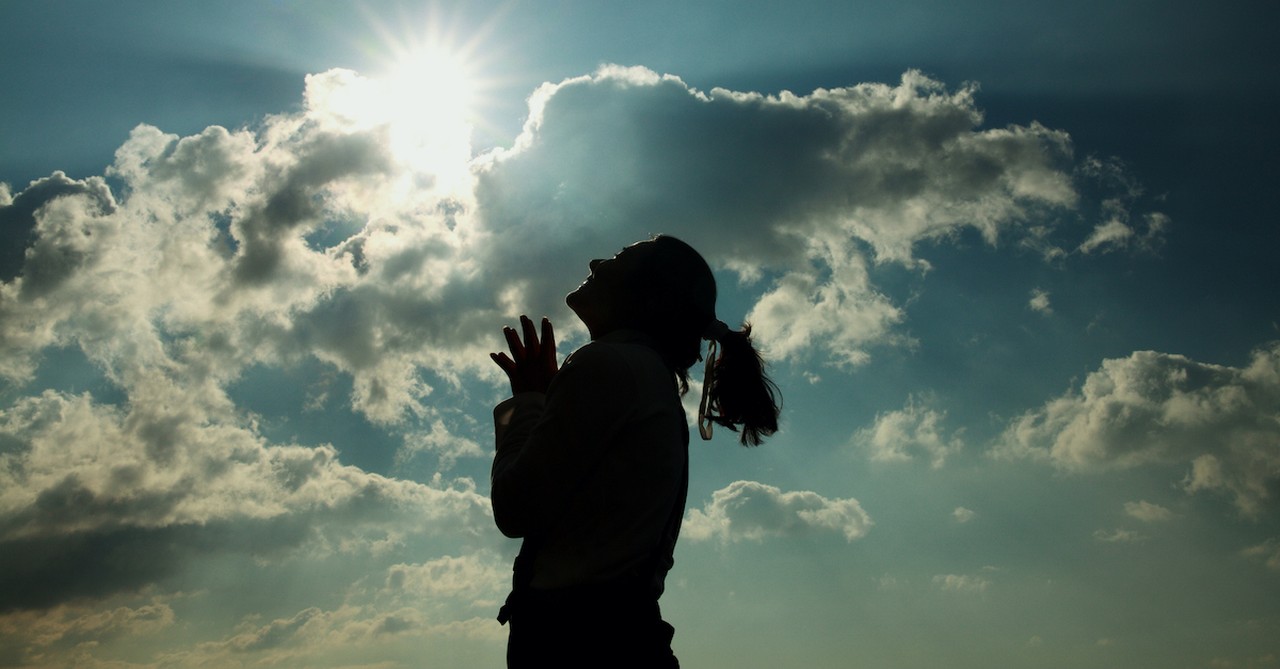 silhouette of woman looking up in gratitude toward sky, thankfulness challenge