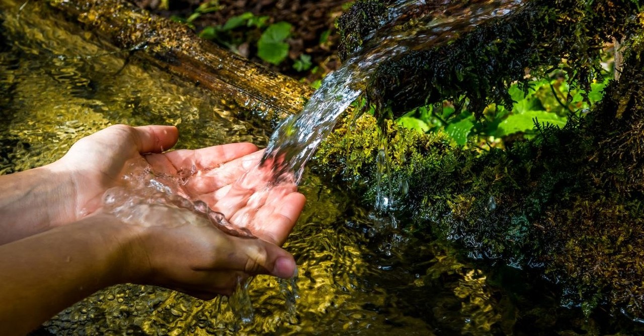 spring water fresh flowing cupped hands catching water