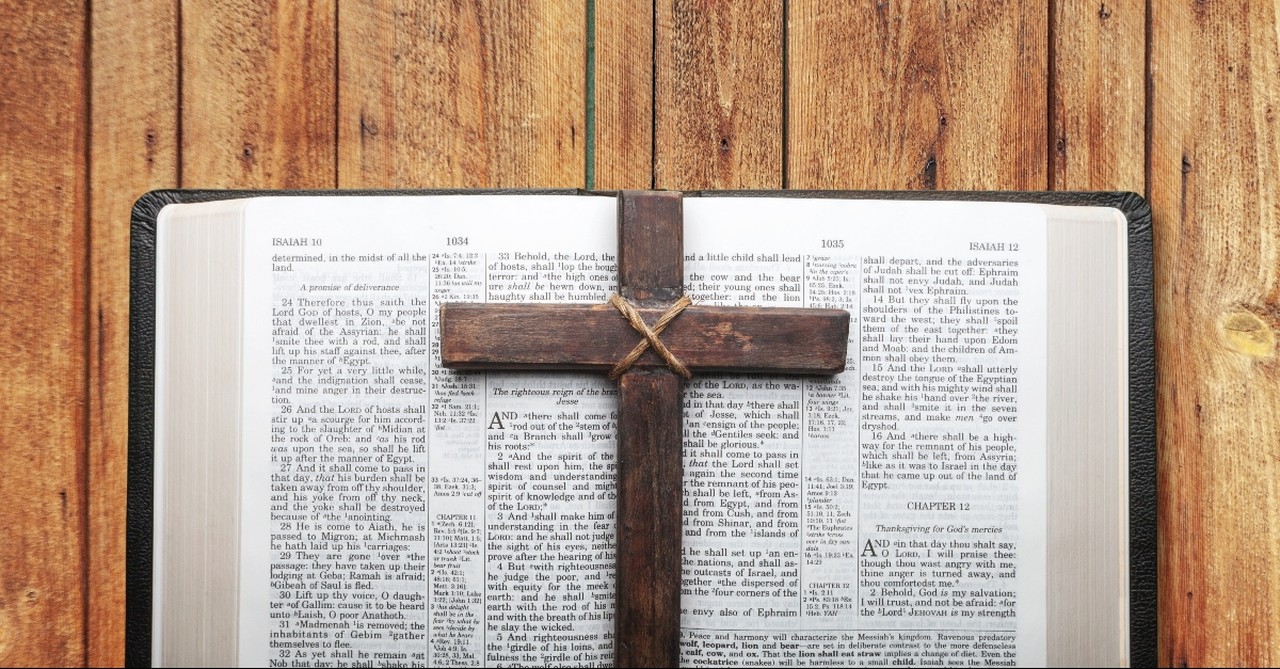 A wooden cross on a Bible