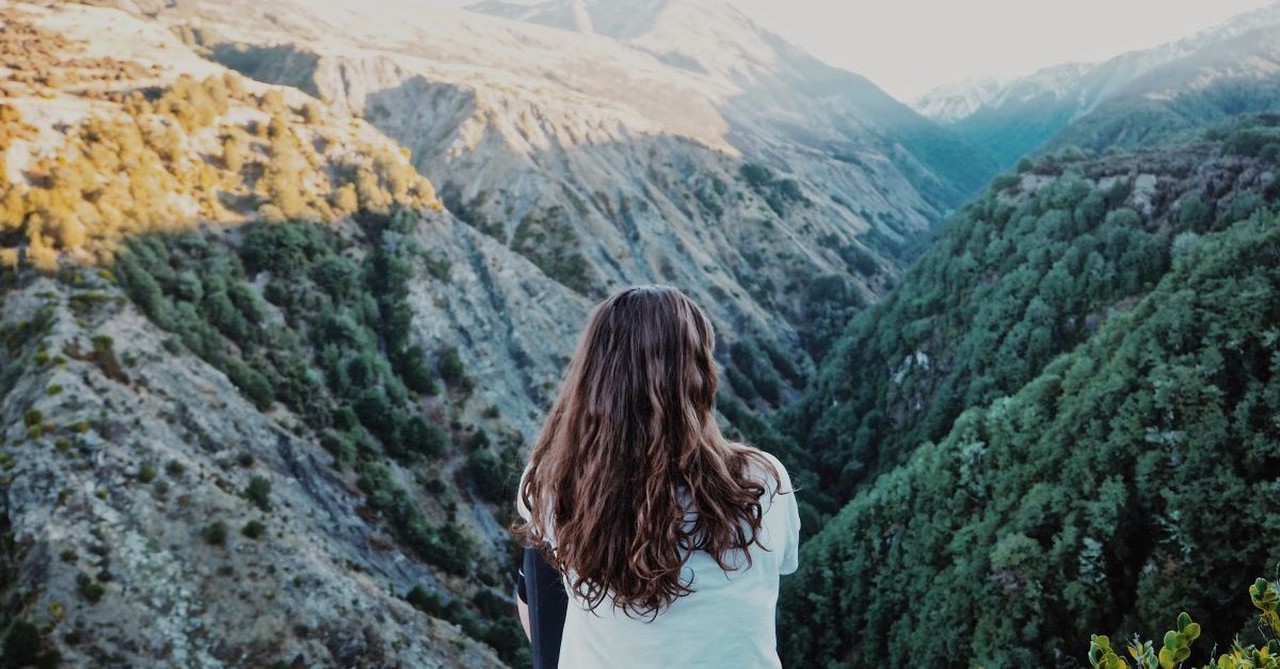 girl overlooking hills and valleys hiking nature mountains