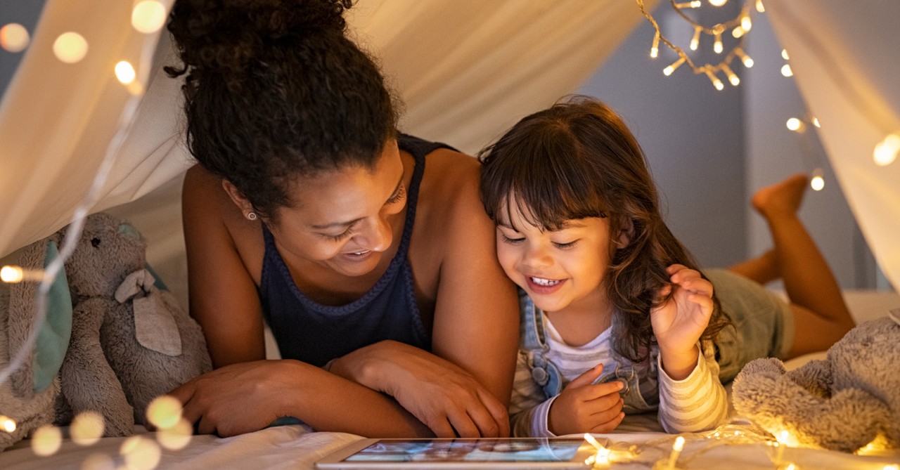 A mother and daughter watching TV, family-friendly movies on Disney Plus