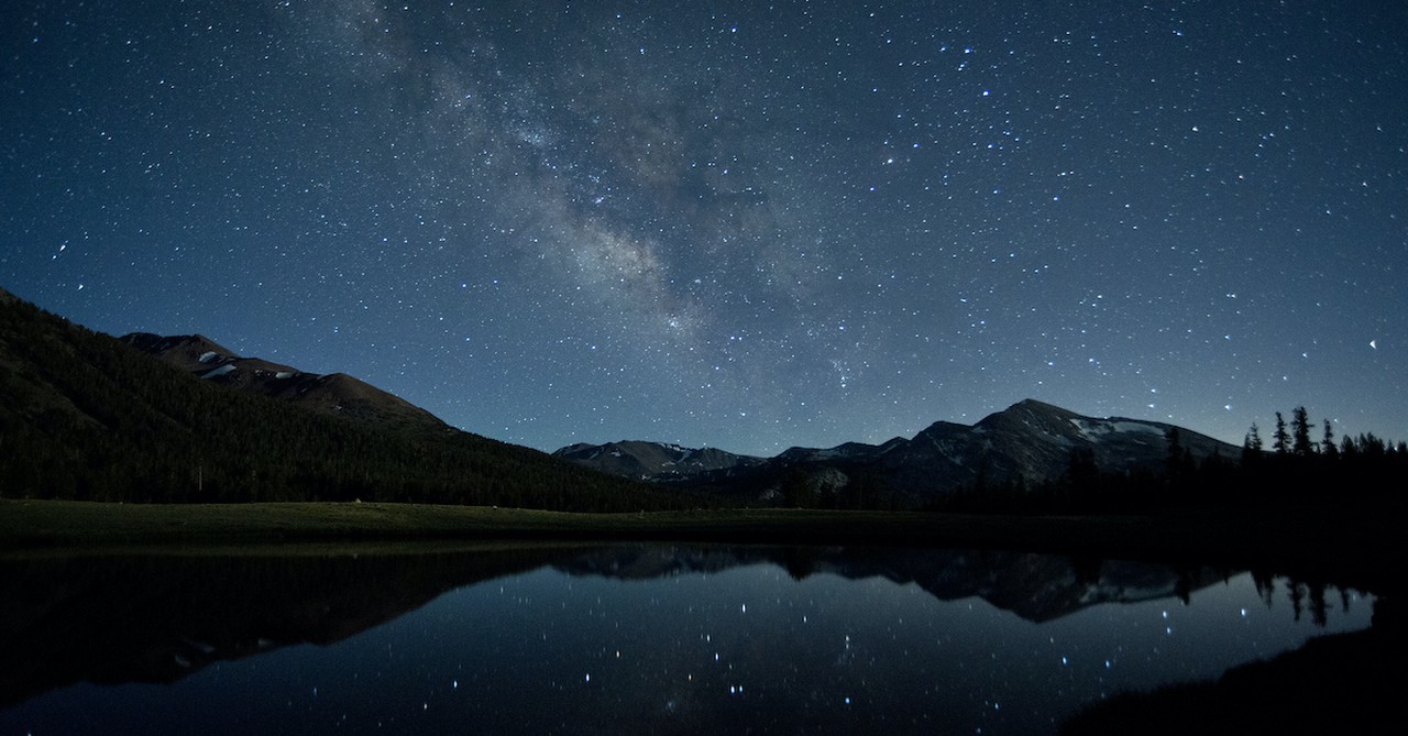 beautiful starry night sky over mountain range and lake, like a thief in the night