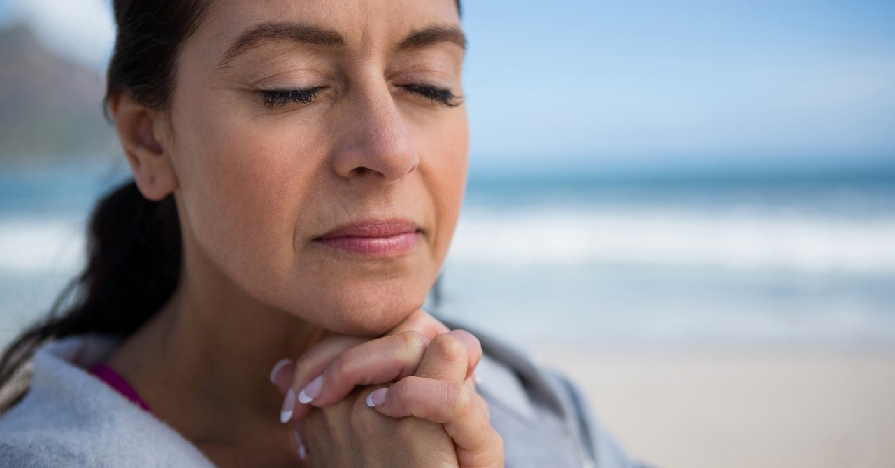 senior woman praying peacefully by seaside, who was eunice