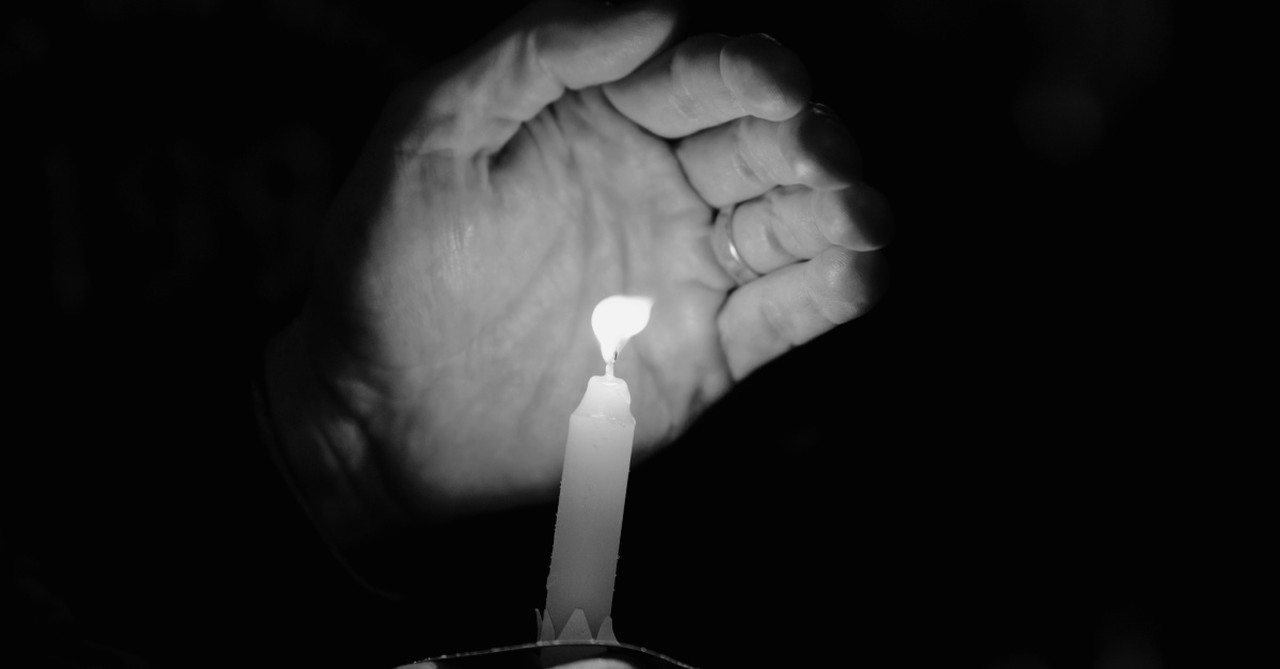 A memorial candle, hundreds attend memorial for Tulsa Race Massacre
