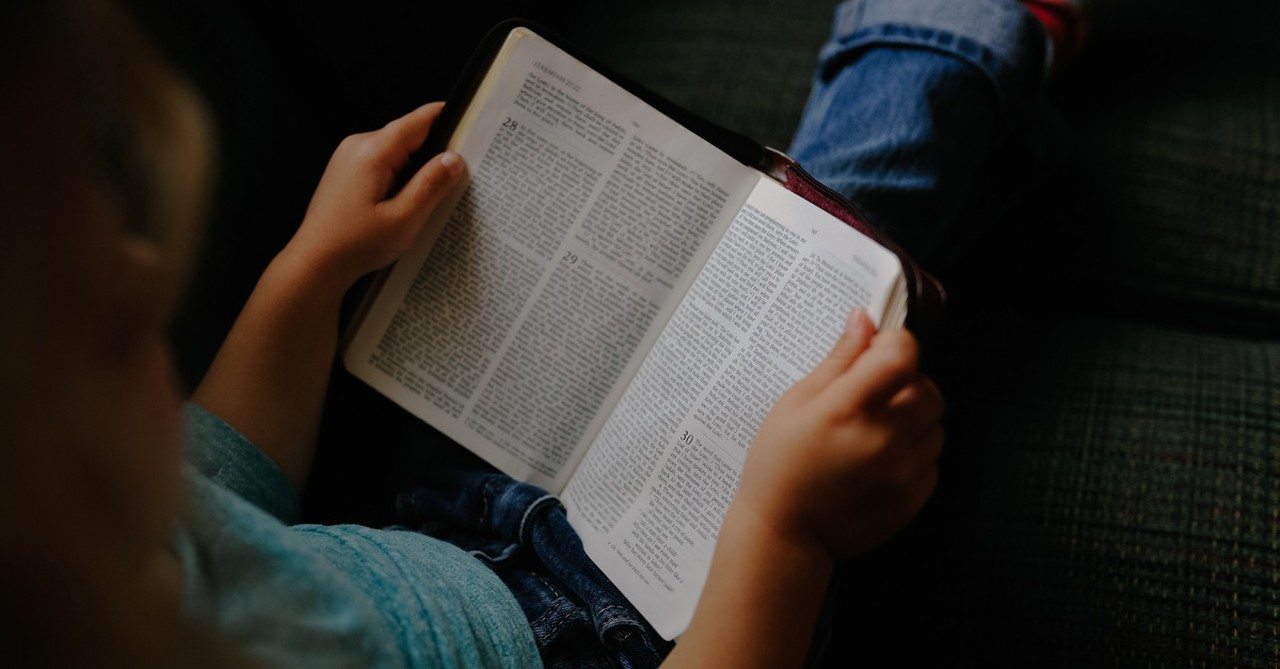 a little girl reading a Bible, Illinois school reverses course after banning girl from reading her Bible