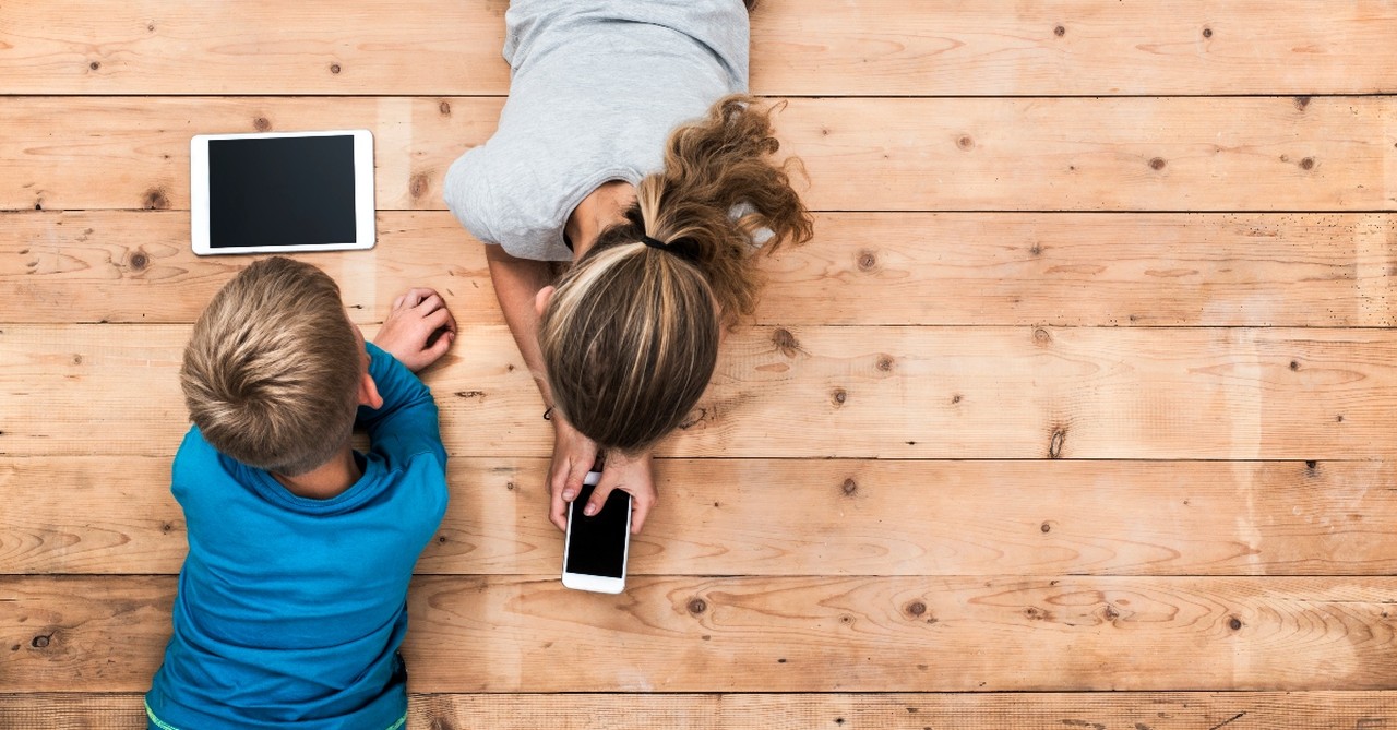 children on floor using electronic devices aerial view