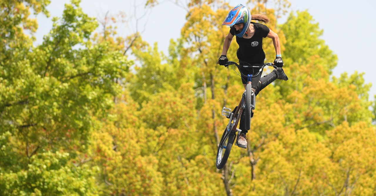 Chelsea Wolfe on a BMX bike, Wolfe under fire for once saying she wanted to burn an American flag on the Olympic podium