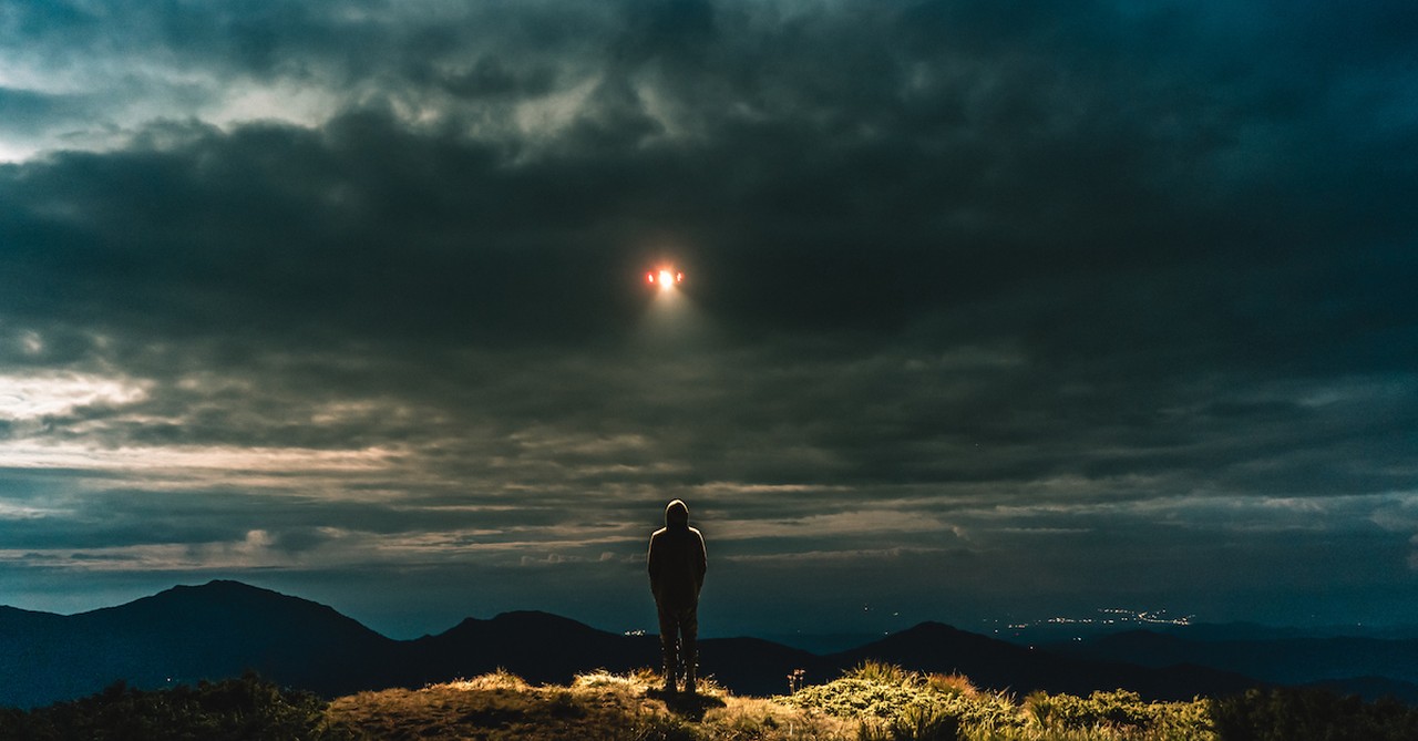 person looking at a UFO, the visitant by mike duran scary books christians can read for halloween