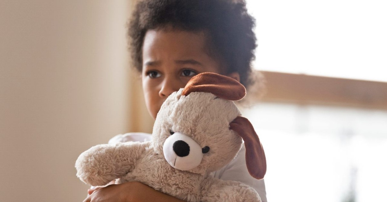 Scared little boy with a teddy bear