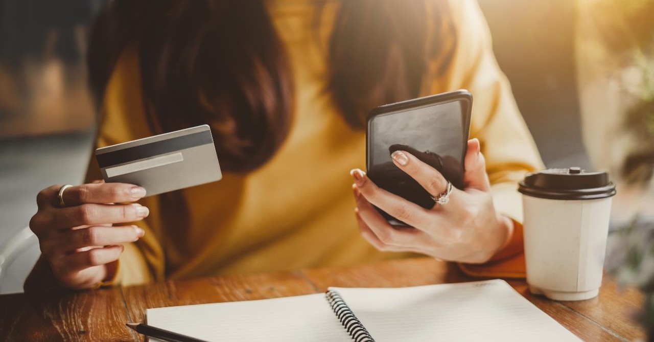 Woman considering her credit card and bank balance