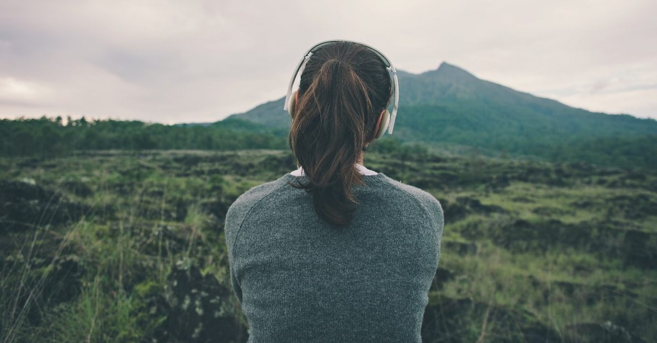 Woman listening looking at the mountains