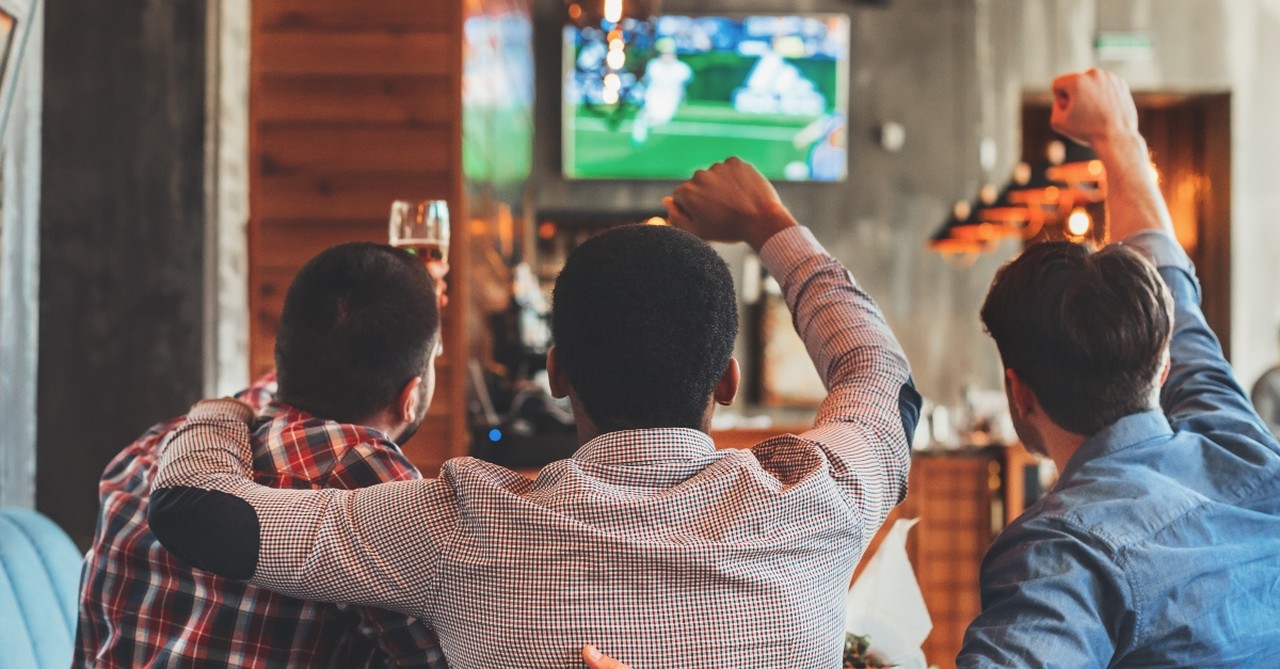 Three men watching a sports game together