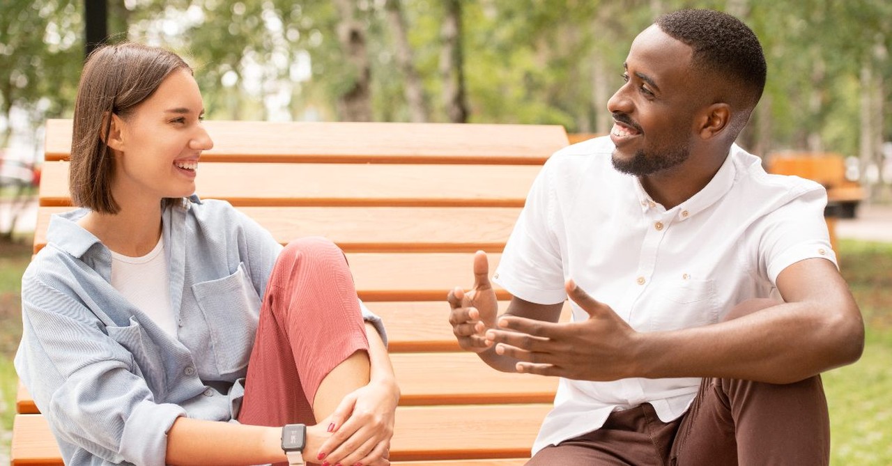 A man and woman talking in the park