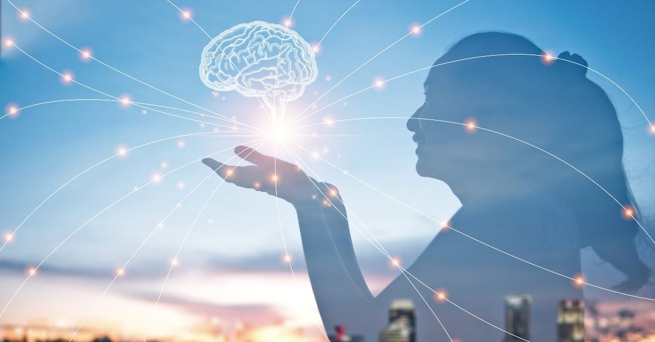 Woman holding up a drawing of a brain