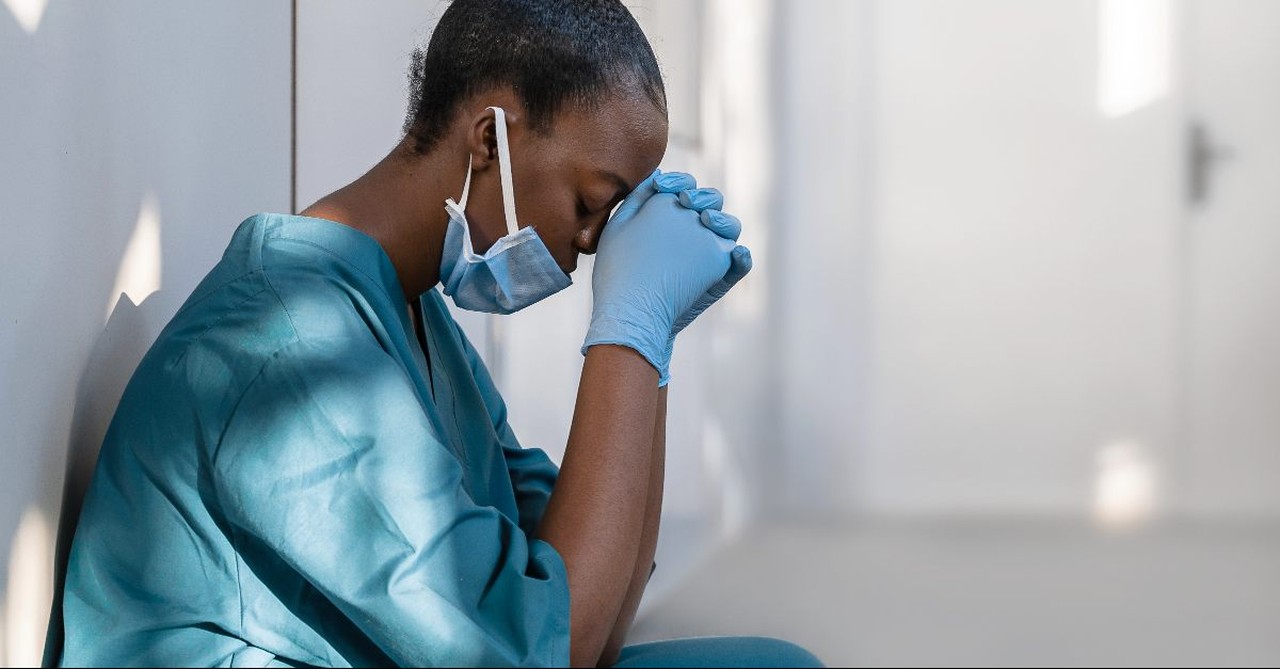 Doctor praying on hospital floor