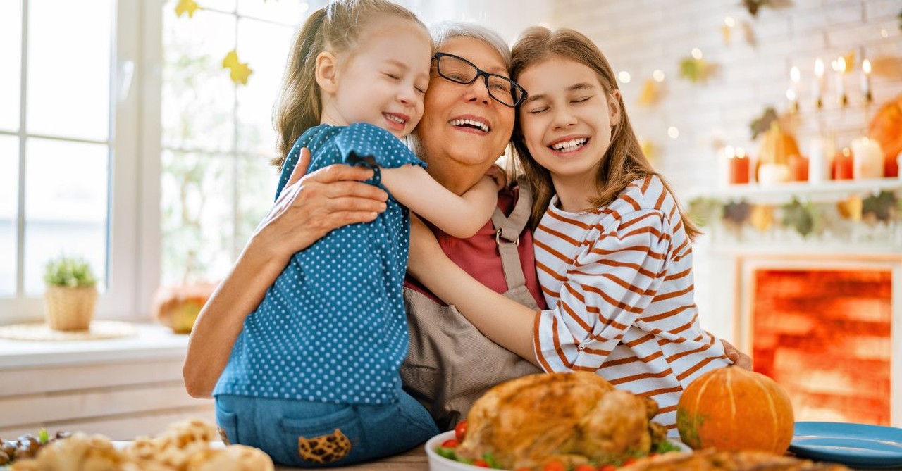 Grandchildren hugging their grandma at Thanksgiving