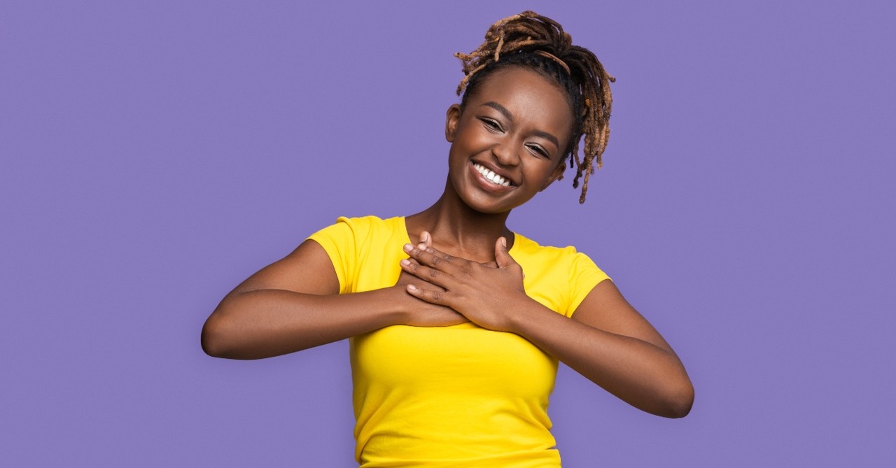 Happy young woman looking thankful