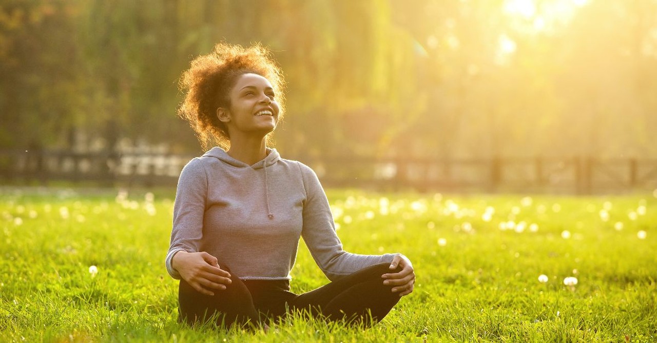 Woman sitting peacefully  in a field