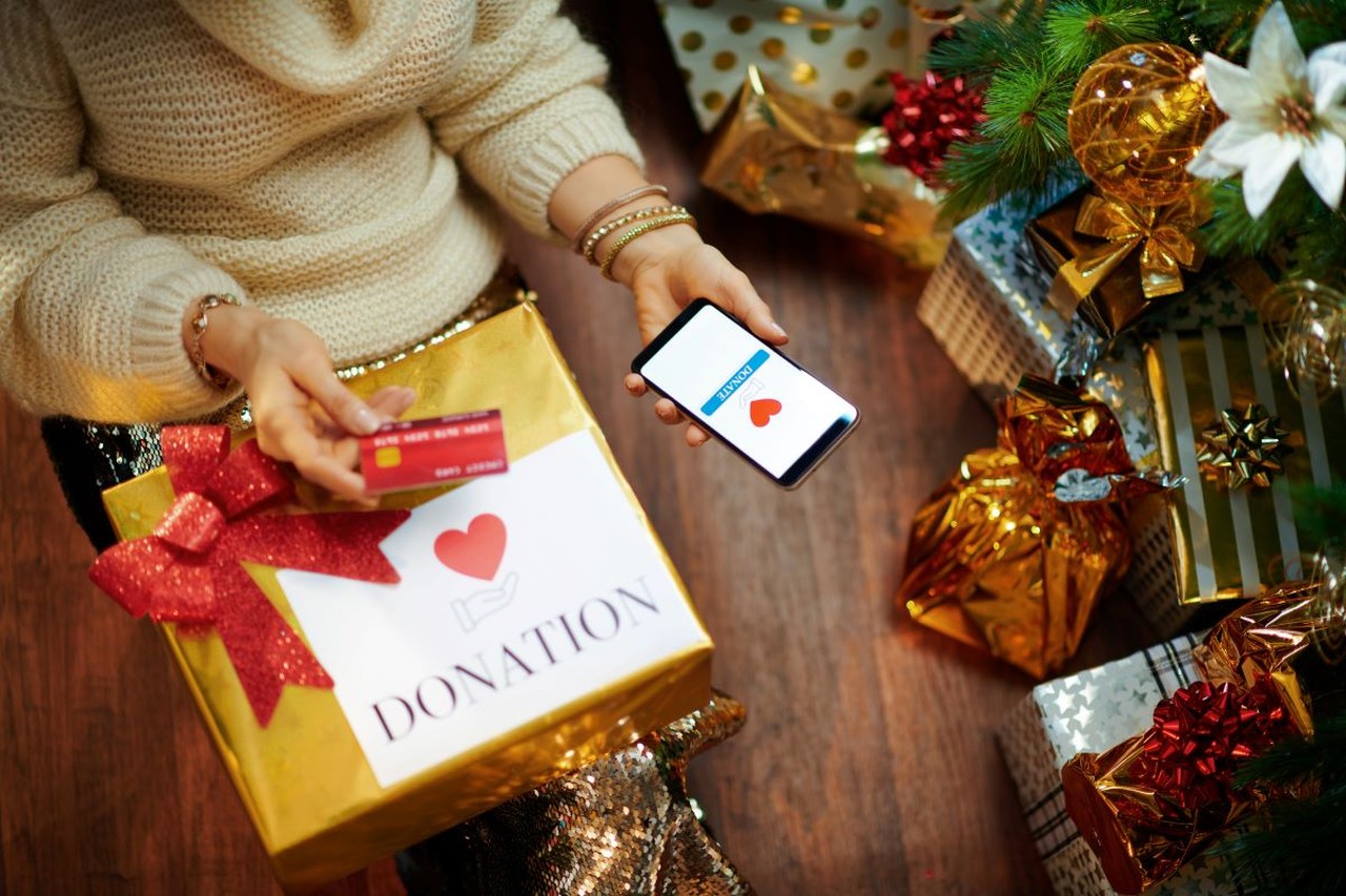 A woman donating Christmas gifts to charity